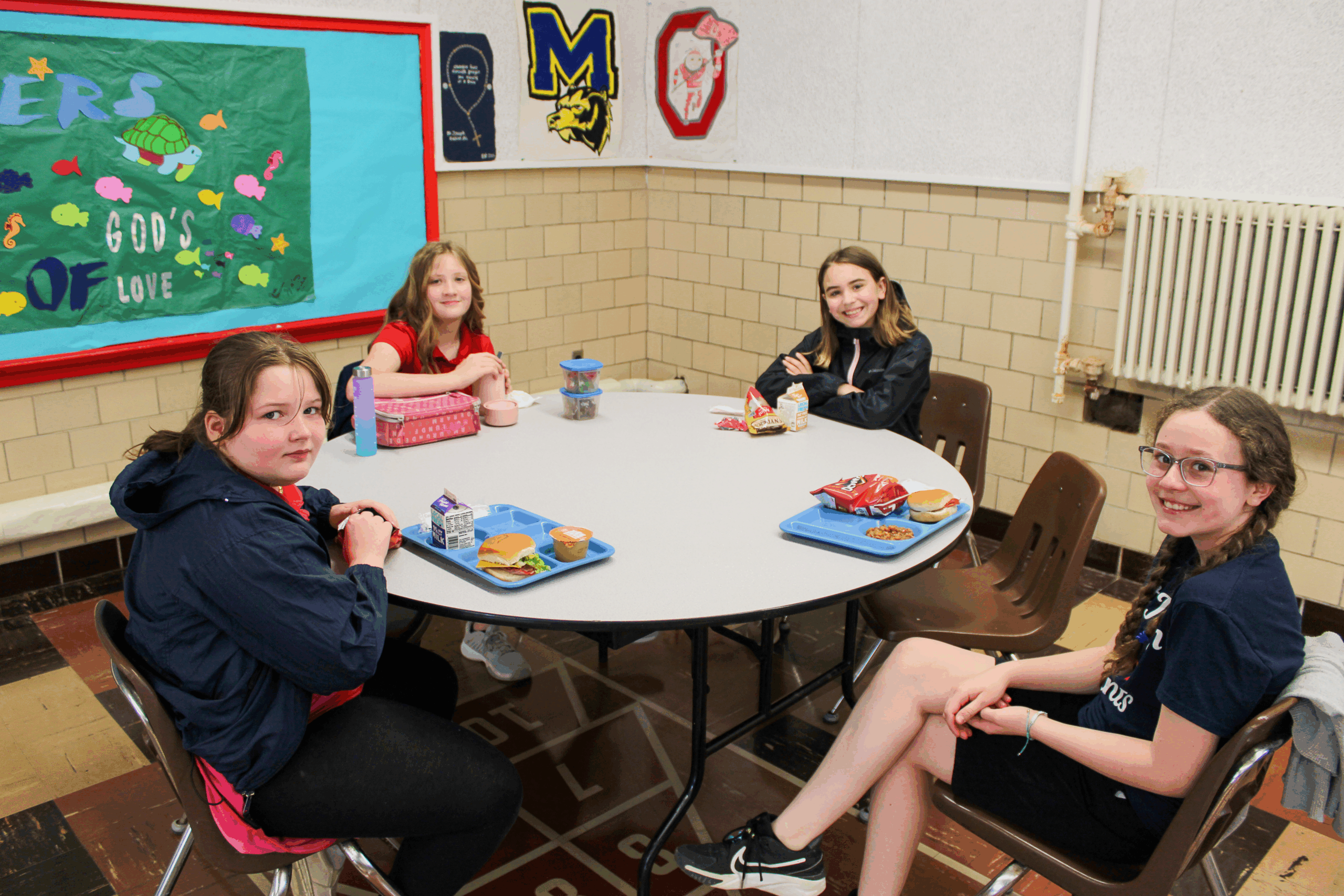 Students eating lunch in the cafeteria.