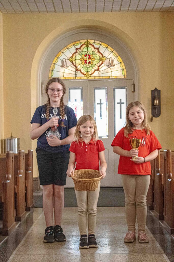 Students bringing the gifts up the aisle for mass
